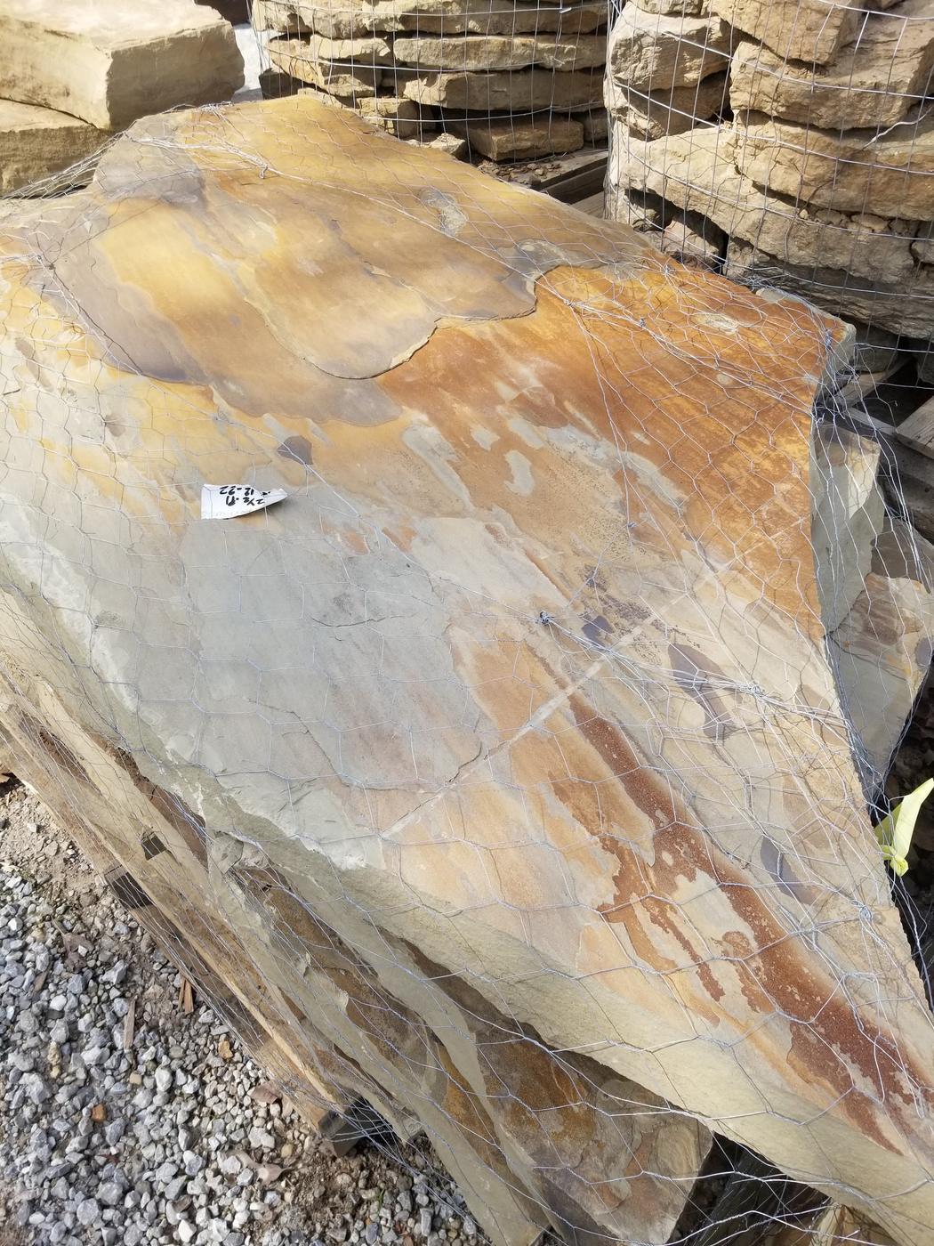 A large flagstone slab banded with rust, gold and sage